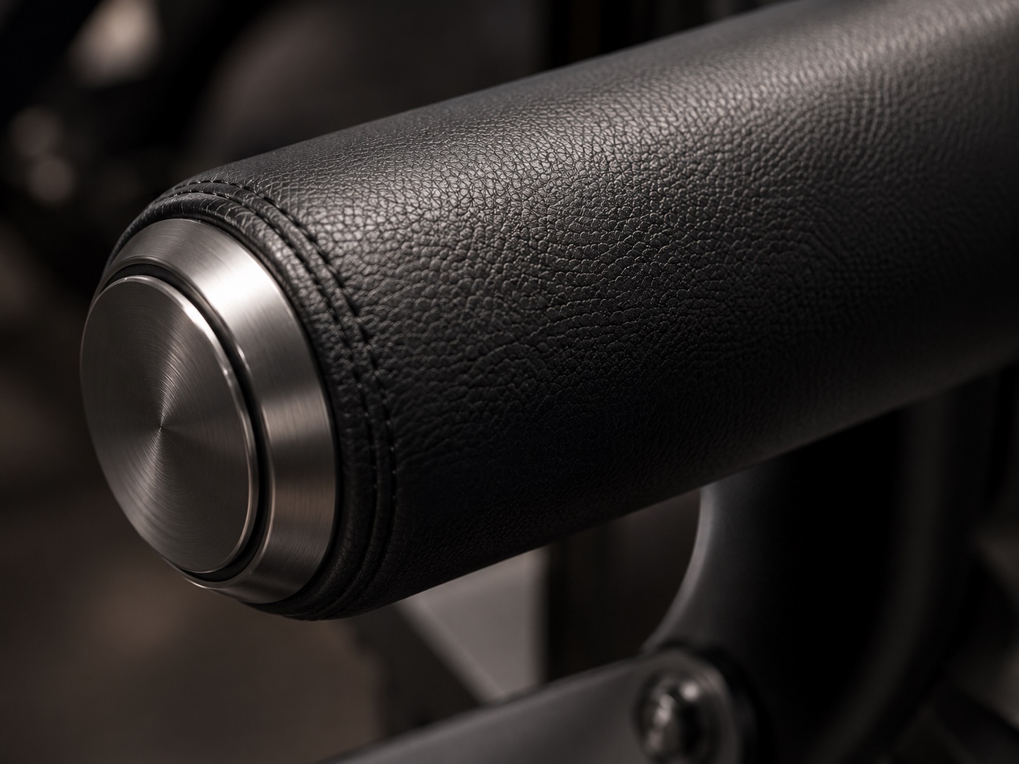 Black leather covered padded roller with metal end cap