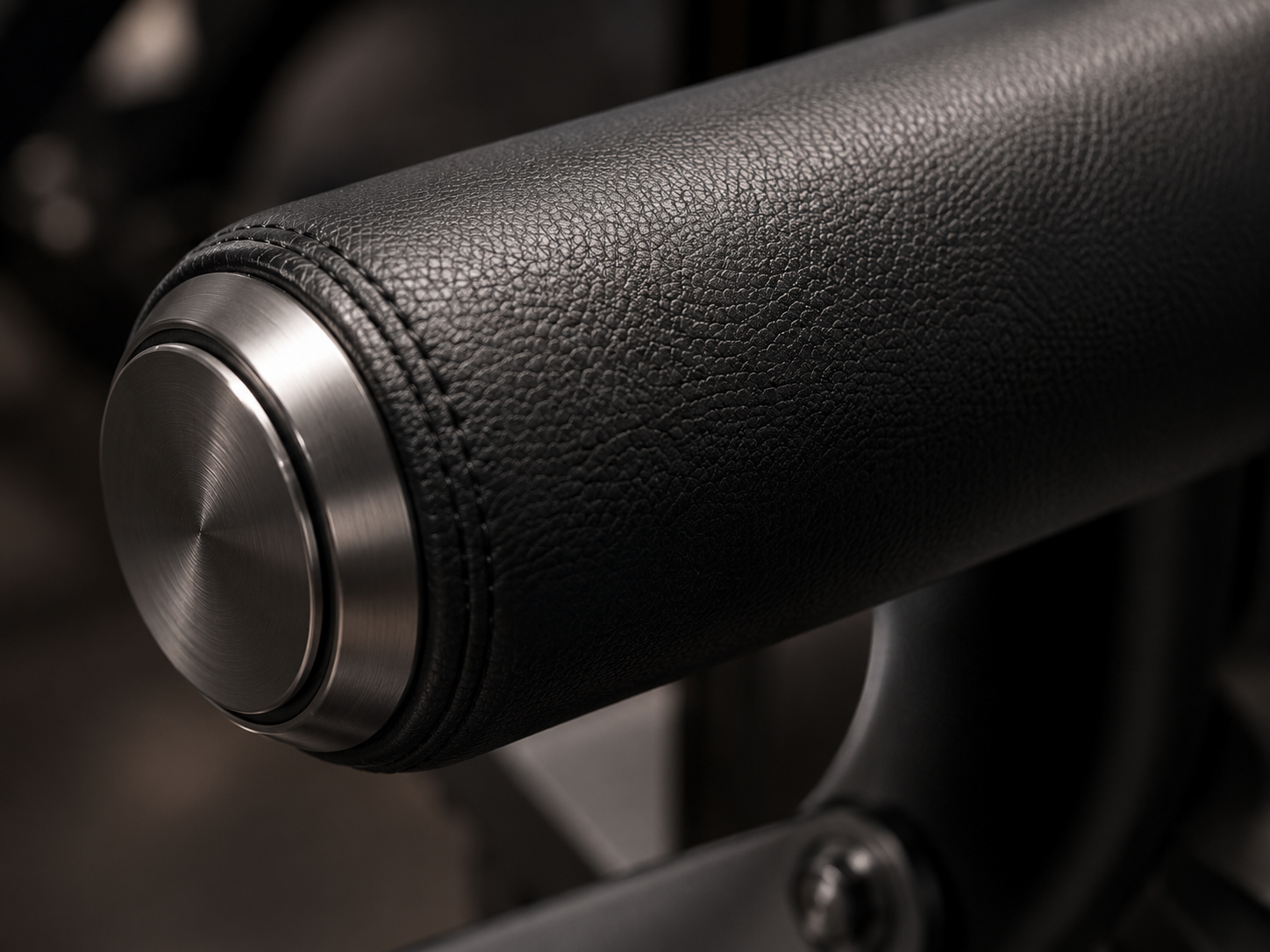 Black leather covered padded roller with metal end cap