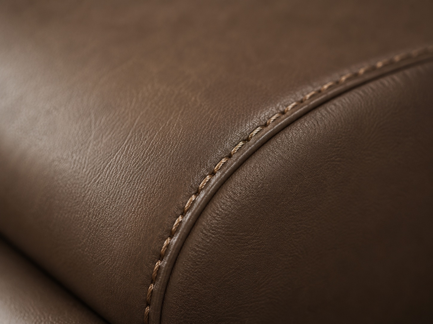 Close up of brown synthetic leather upholstery stitching detail