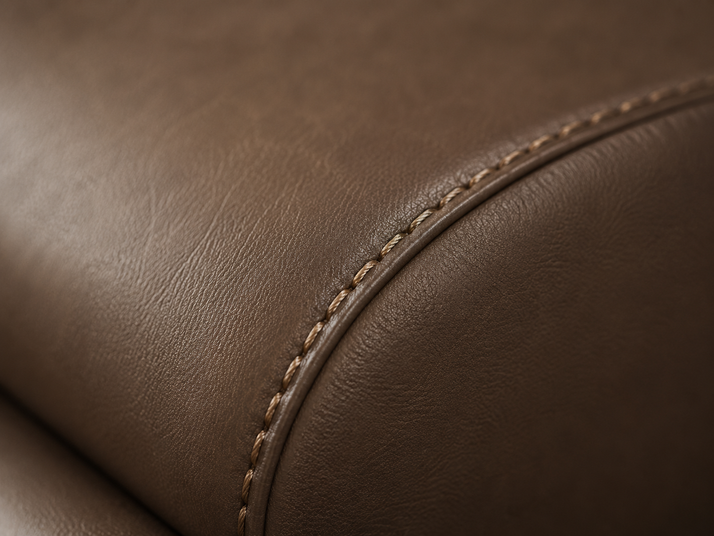 Close up of brown synthetic leather upholstery stitching detail